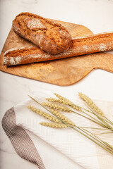 Artisan bread with wheat cereals on a stone table