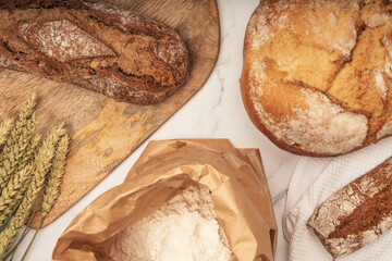 Artisan bread with wheat cereals on a stone table