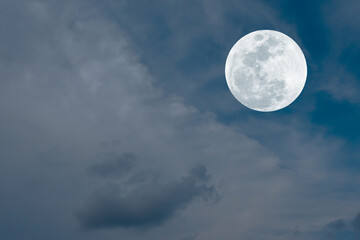 Fototapeta na wymiar Full moon and clouds on the sky. 