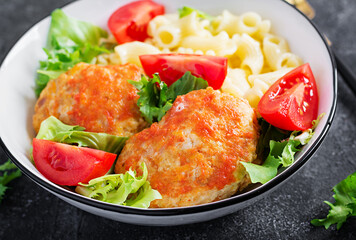 Creste pasta and chicken meatballs in tomato sauce.