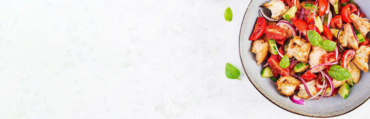 Tuscan Panzanella, traditional Italian salad with tomatoes and bread. Vegetarian panzanella salad. Mediterranean healthy food. Top view, banner