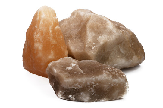 three large pieces of natural salt on a white isolated background