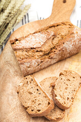 Artisan bread with wheat cereals on a stone table