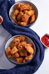 Crispy Chicken Pops Korean Style with Ketchup Chili sauce. Dark tone.
