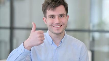 Portrait of Young Man showing Thumbs Up Sign 