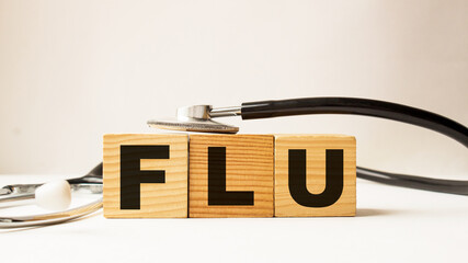 word FLU on wooden blocks. medical concept . the medicine