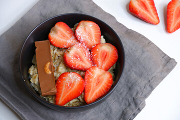 Oatmeal with strawberries. Tasty breakfast. Cooking. Porridge.