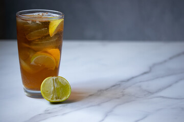 Thai style sweet iced lemon tea on a gray background.