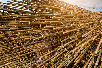 steel rebar for reinforcement concrete at construction site with house under construction background,Industrial background.Rusty rebar for concrete pouring.