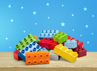 Colorful children building bricks on desk