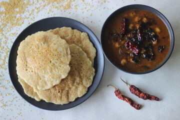 Rice pancakes made with foxtail millets flour. An experimental version of a popular Kerala dish called kallapam served with Chana masala, a dish made with chickpea.
