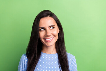 Photo of cheerful brown hair lady look empty space wear blue shirt isolated on pastel green color background