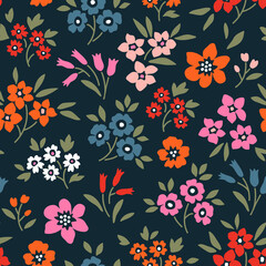 Vintage floral background. Floral pattern with small colorful flowers on a navy blue background. Seamless pattern for design and fashion prints. Ditsy style. Stock vector illustration.