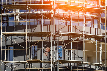 Extensive scaffolding providing platforms for work in progress on a new apartment block,Tall...