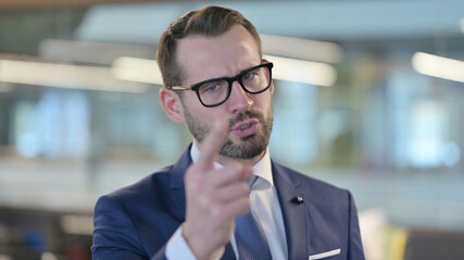 Portrait of Angry Middle Aged Businessman Arguing, Shouting 