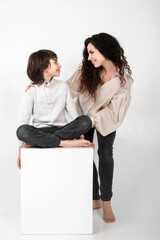 boy 10 years old and mother on a white background in the studio
