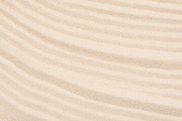 Fototapeta na wymiar Sandy texture, abstract lines on the top of soft sand, top view, layout