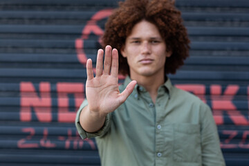 Portrait of mixed race man holding hand making a stop gesture