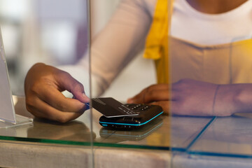 Midsection of mixed race woman paying by card