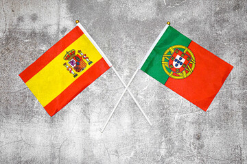 Hand flags of Spain and Portugal on Abstract background