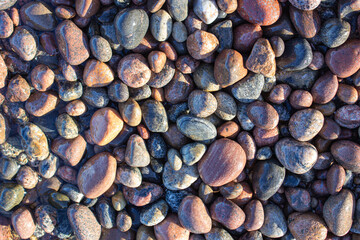 Small pebbles. Pebbles on the coast. Sea pebbles.