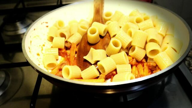 making italian pasta with bacon and carrot