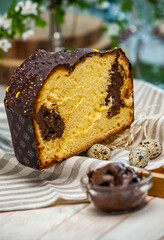 Panettone is the traditional Italian dessert for easter in 2021. Homemade panettone covered in chocolate and sprinkles. Bread served as dessert.