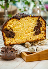 Fototapeta na wymiar Panettone is the traditional Italian dessert for easter in 2021. Homemade panettone covered in chocolate and sprinkles. Bread served as dessert.