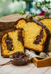 Panettone is the traditional Italian dessert for easter in 2021. Homemade panettone covered in chocolate and sprinkles. Bread served as dessert.