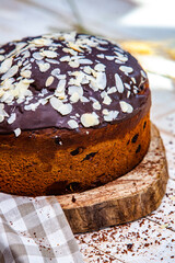 Panettone is the traditional Italian dessert for easter in 2021. Homemade panettone covered in chocolate and sprinkles. Bread served as dessert.