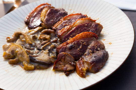 Fried duck breast Magre served with mushrooms. High quality photo