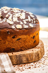 Panettone is the traditional Italian dessert for easter in 2021. Homemade panettone covered in chocolate and sprinkles. Bread served as dessert.