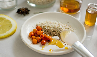 Home cosmetic mask for face skin from natural ingredients of fresh berries, oatmeal, honey, essential oils. Ingredients for making handmade natural cosmetics, flat lay, copy space 