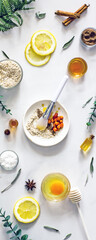 Home cosmetic mask for face skin from natural ingredients of fresh berries, oatmeal, honey, essential oils. Ingredients for making handmade natural cosmetics, flat lay, copy space 