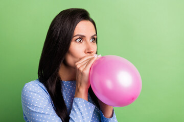 Profile photo of impressed brown hair lady blow balloon wear blue dress isolated on green color background