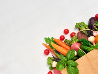 Fototapeta na wymiar Vegetables in paper bag on white background.