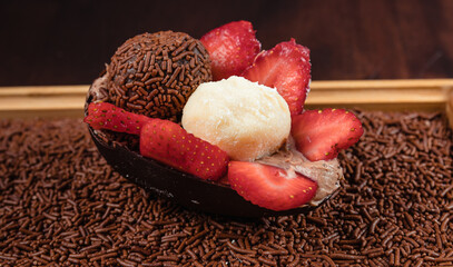 Chocolate Easter Egg filled with brigadeiro (brigadier) and strawberries, Goumert egg chocolate tradition in Brazil.
