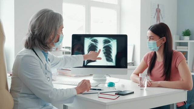 Mature female doctor in white lab coat 