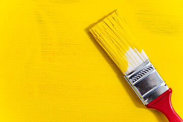 Brush on yellow textured background close-up