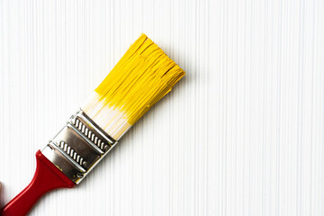 Red brush on a light textured background close-up