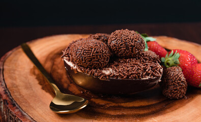Chocolate Easter Egg filled with brigadeiro (brigadier) and strawberries, Goumert egg chocolate tradition in Brazil.