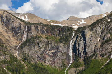 Waterfalls at Avalanche Lake and surrounding mountain range at Glacier National Park