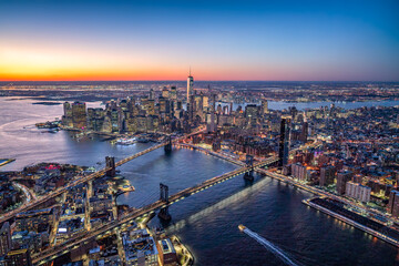 Aerial view of Lower Manhattan with Brooklyn Bridge and Manhattan Bridge at sunset, New York City, USA