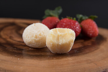 powdered milk brigadeiro (brigadier), typical candy tradition in Brazil. Powdered milk brigadeiro with strawberries
