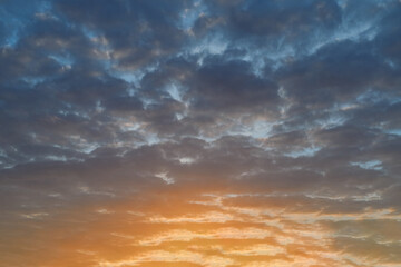 The sky at sunset. Cumulus clouds lit by the rays of the setting sun.