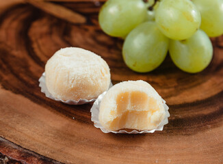 powdered milk brigadeiro (brigadier), typical candy tradition in Brazil. Powdered milk brigadeiro with green grapes