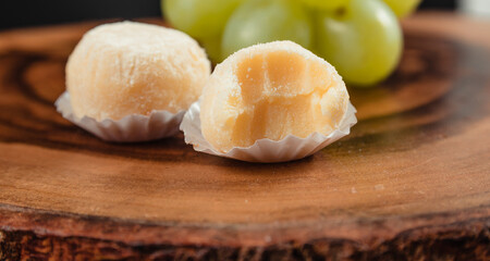 powdered milk brigadeiro (brigadier), typical candy tradition in Brazil. Powdered milk brigadeiro with green grapes
