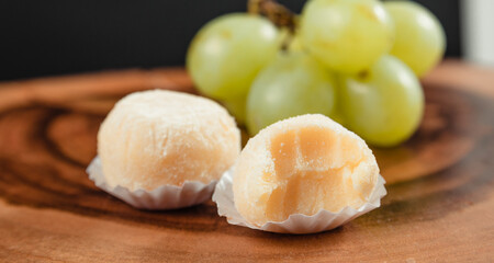 powdered milk brigadeiro (brigadier), typical candy tradition in Brazil. Powdered milk brigadeiro with green grapes