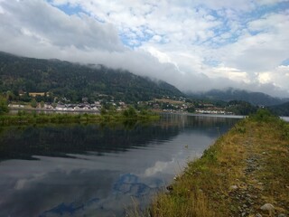 clouds over the lake with view of small town