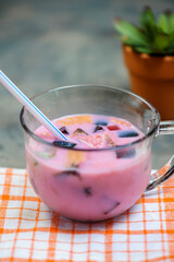 Es campur or ice mixed dessert is one of the typical Indonesian drinks that is made by mixing various types of ingredients like fruits and jelly in sweet syrup. Selective focus, Blurry